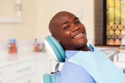 man smiling during his visit to Danos Dental