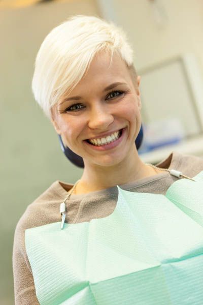 woman showing off her smile after getting dental implants placed