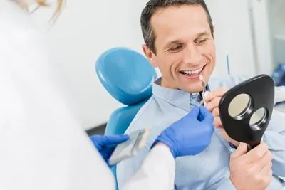 man picking out a color for his dental veneers