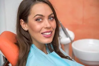 woman laying back in a dental chair at Danos Dental