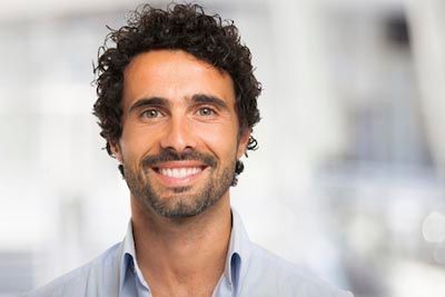 man smiling after getting a dental implant at Danos Dental