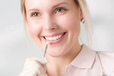 woman choosing which color dental veneers she wants