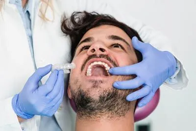 patient being fitted for his new SureSmile aligners from Danos Dental