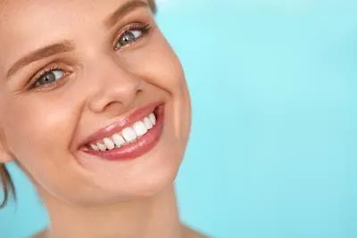 woman showing off her restored smile after visiting Danos Dental