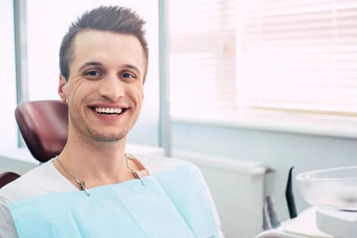 man smiling big during his visit to Danos Dental