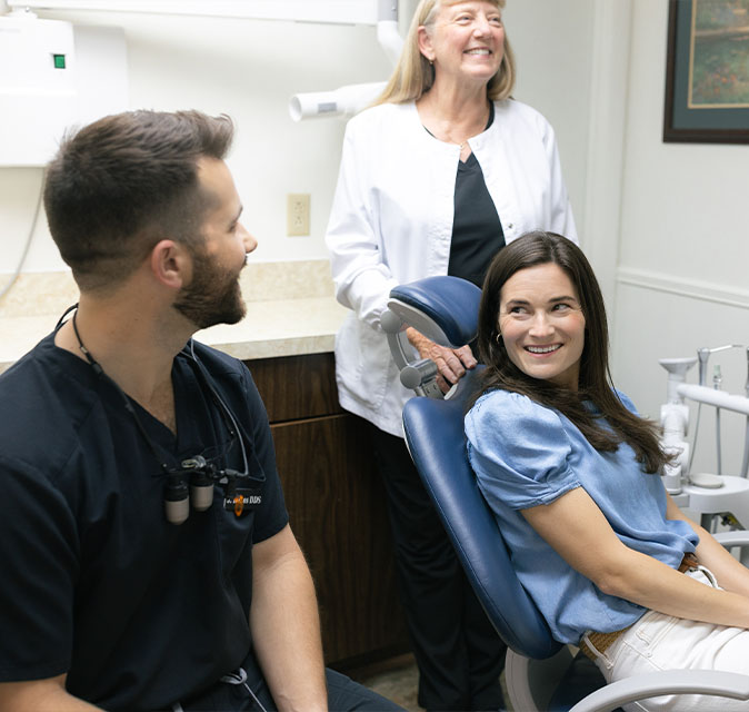 Dr. Danos and his dental assistant speaking to a patient about anxiety-free sedation dentistry
