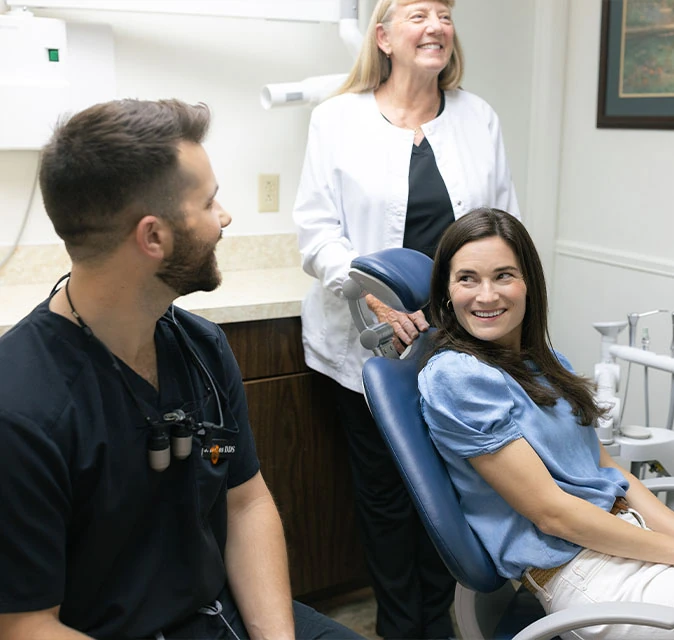 Dr. Danos and his dental assistant speaking to a patient about anxiety-free sedation dentistry